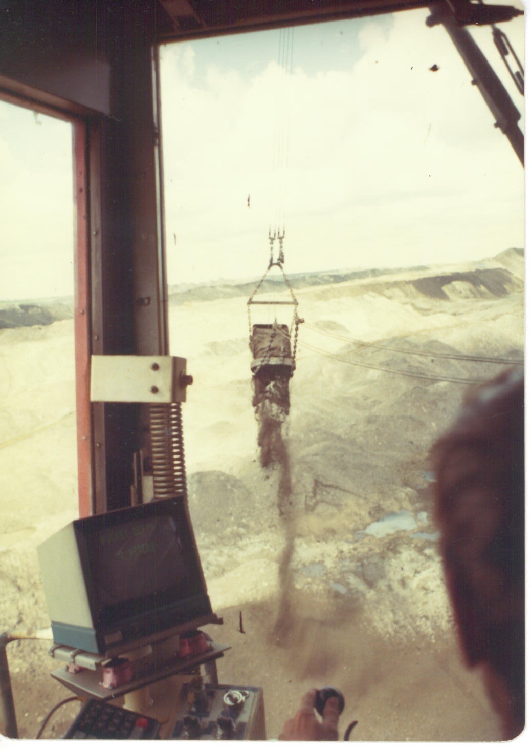 Dragline operator cab controls interior Athabasca oil sands Alberta 1980 loaded bucket swinging